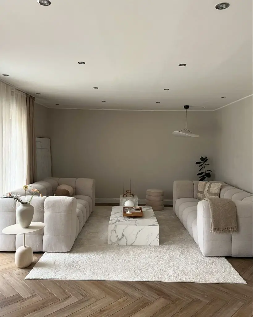 Minimalist living room with curved sofas and marble coffee table