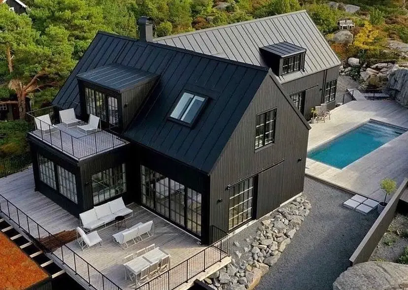 Modern black and grey barndominium with rooftop deck and poolside terrace