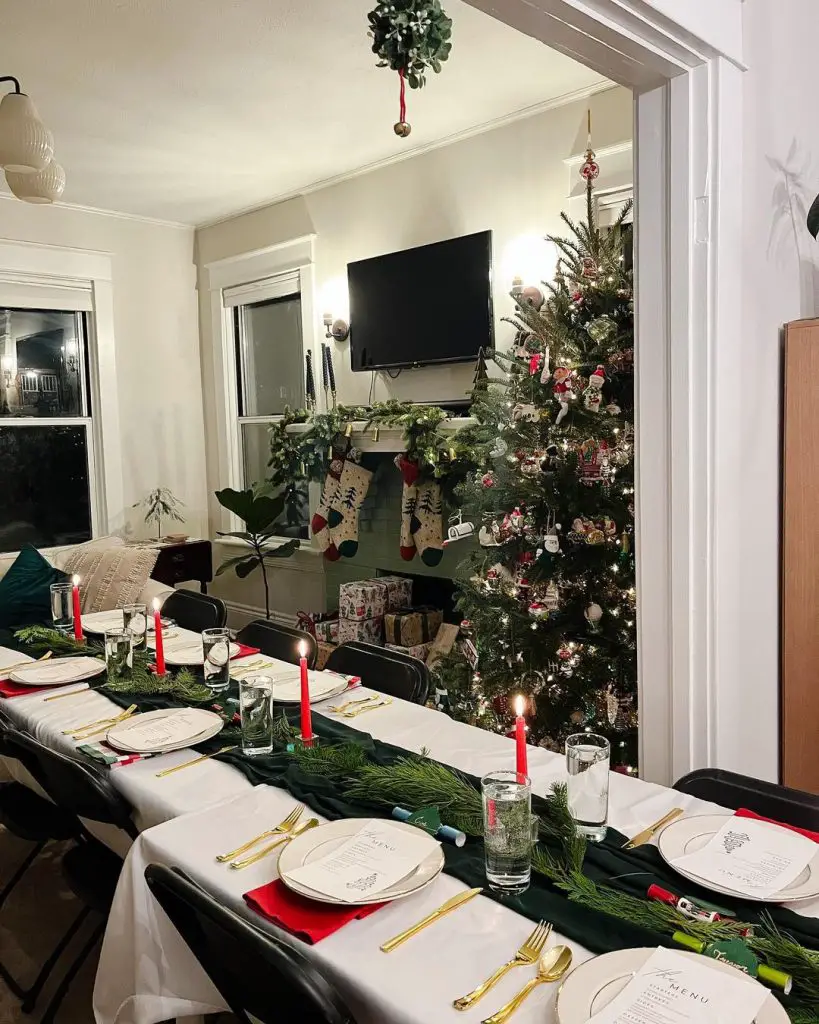 Christmas Eve dinner table with decorated tree and fireplace