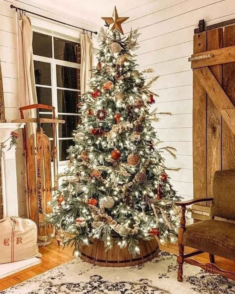 Decorated tree and fireplace create a cozy Christmas corner.
