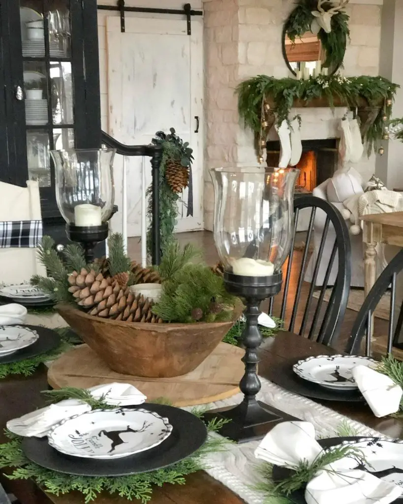 Farmhouse-style Christmas table with pinecone centerpiece and cozy fireplace background