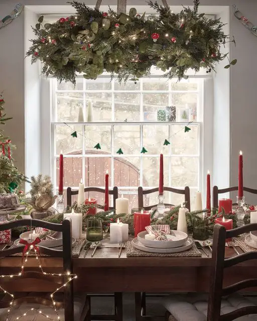 Christmas table set by window with garland