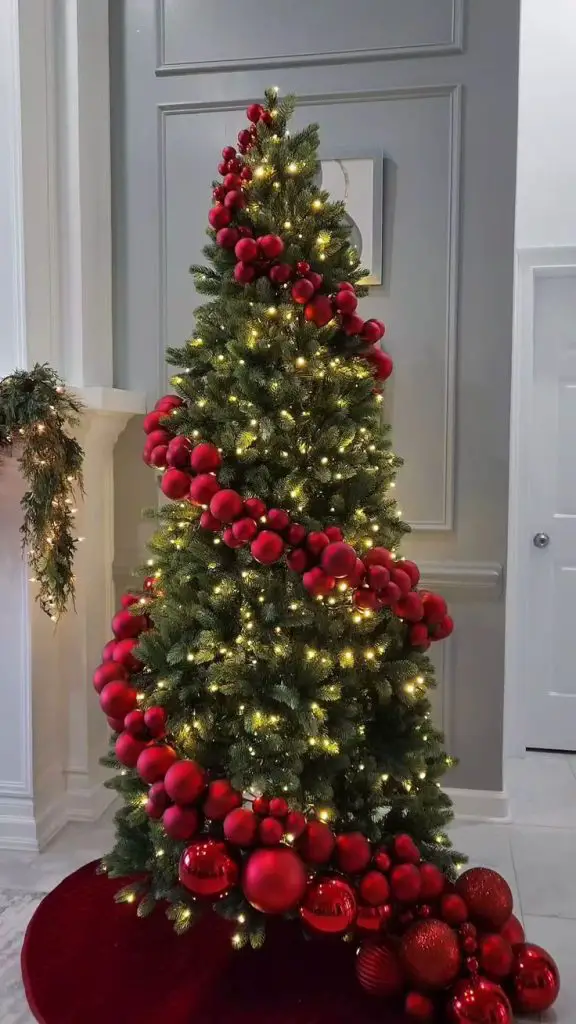 Christmas tree with spiraling red ornaments and twinkling lights