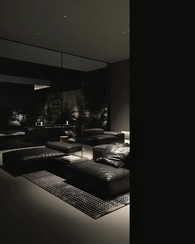 Minimal furnishings create a quiet sitting area bathed in filtered late afternoon light.