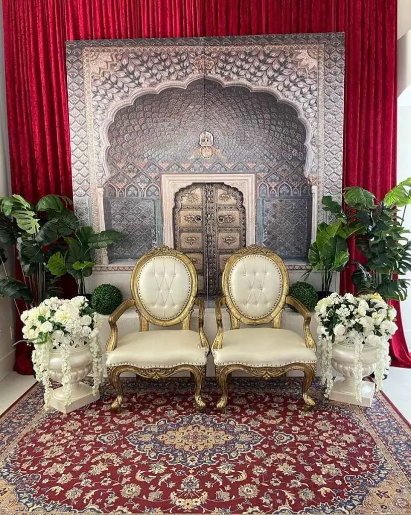 Gold decorated throne room with flowers for wedding ceremony.