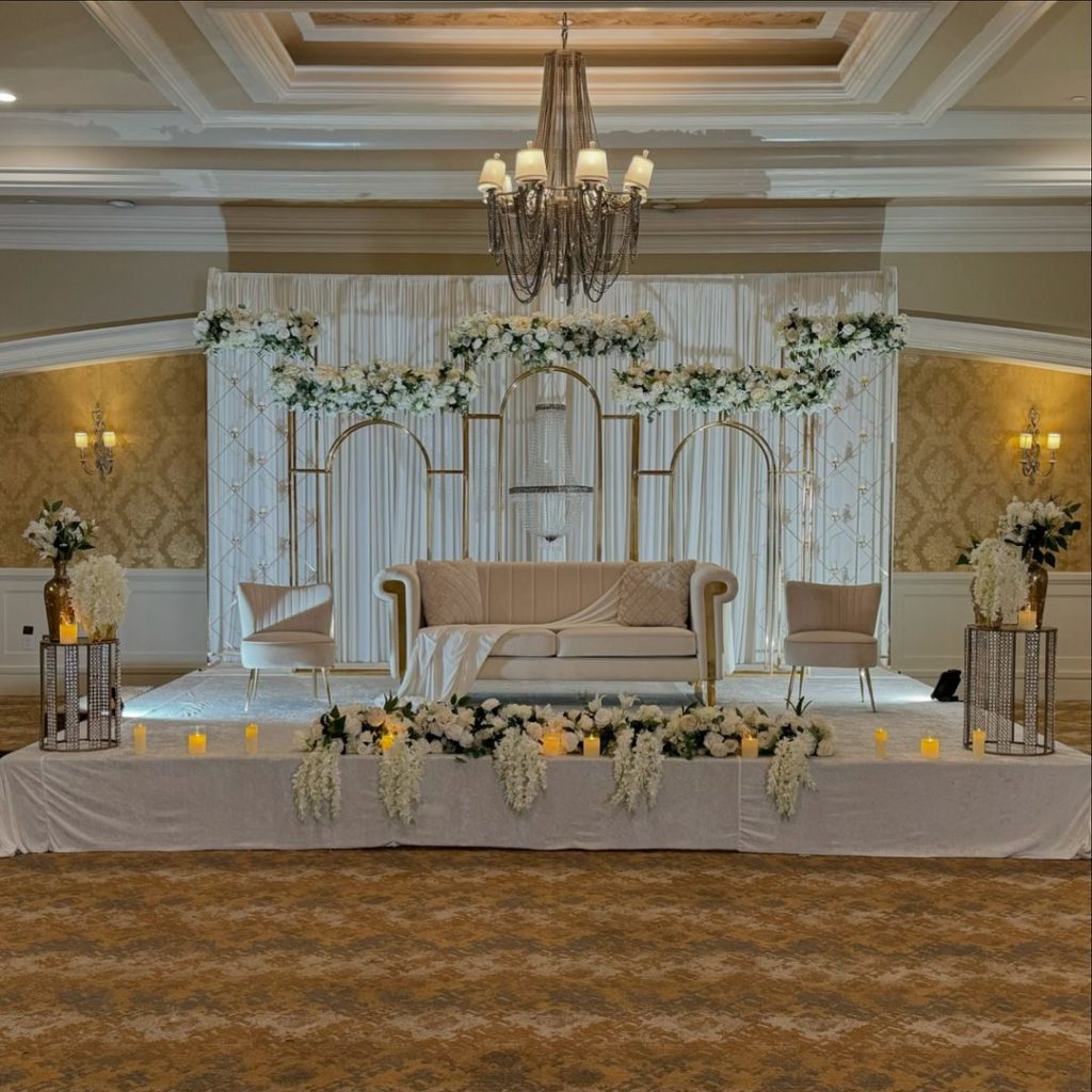 Elegant wedding stage with golden arches and white flowers