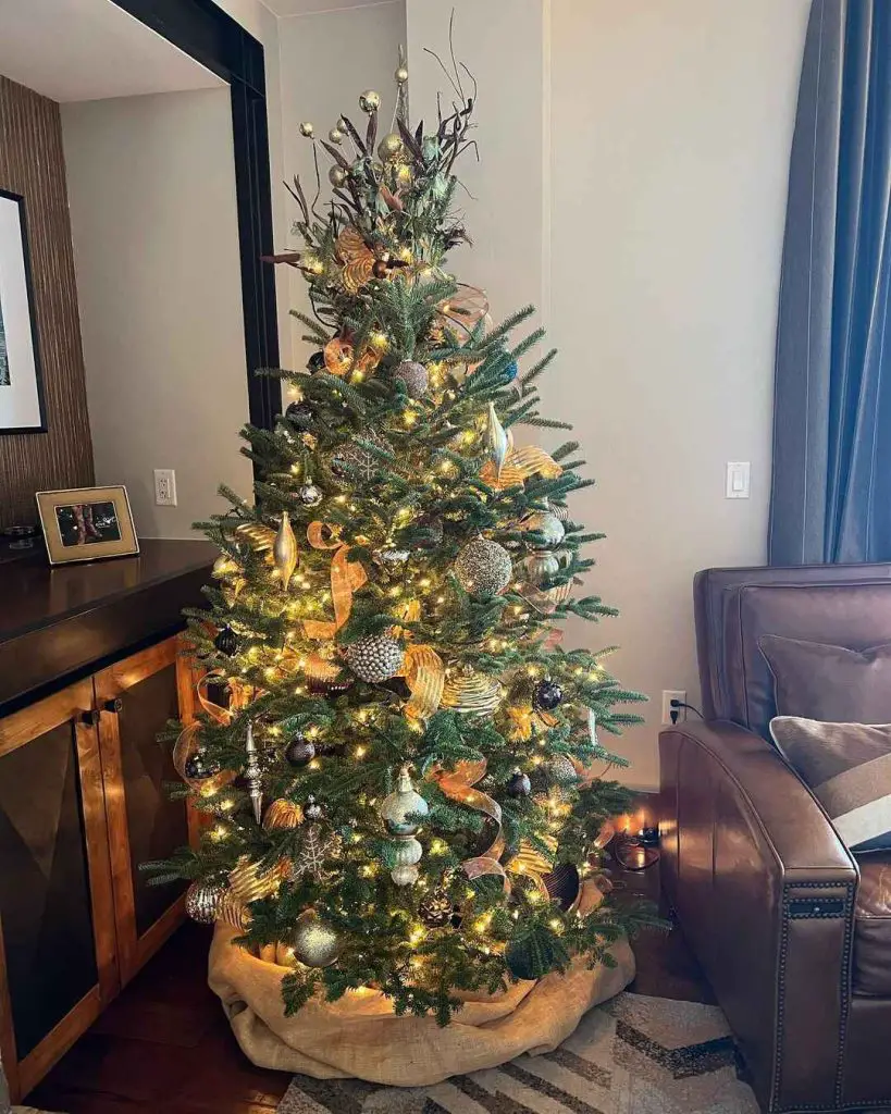 Christmas tree with gold decorations and woodland elements