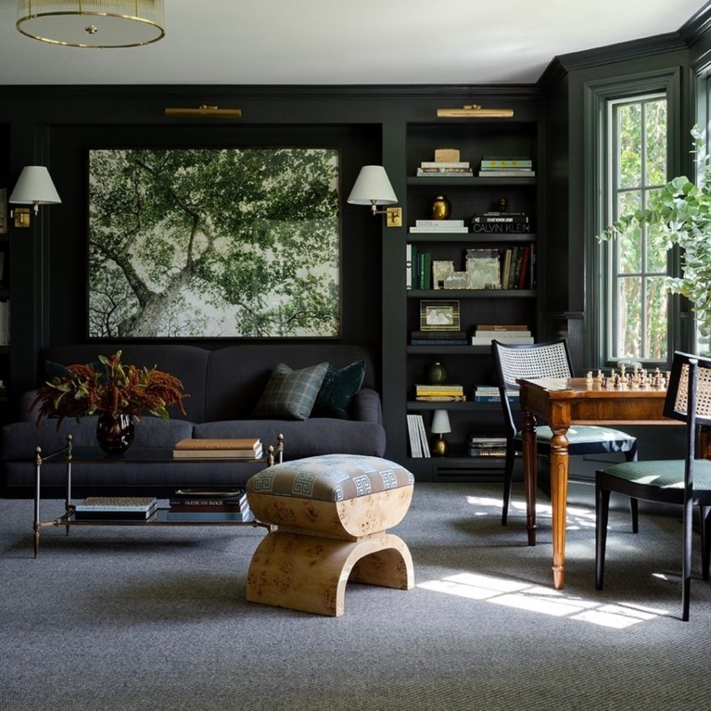 Dark green library with nature art and diverse furniture