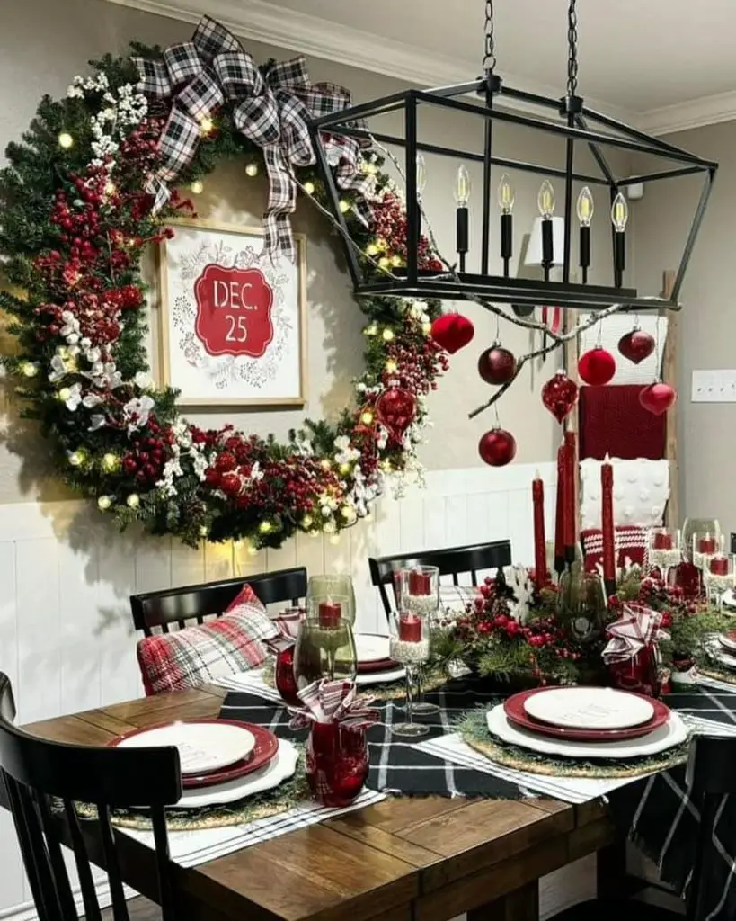 Rustic Christmas dining area with large wreath and decorated table
