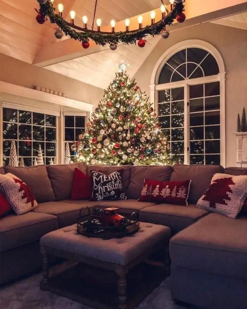 Christmas lounge aglow with tree lights and fireplace warmth.
