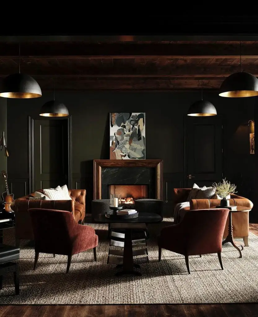 Dark living room with leather sofas and lit fireplace