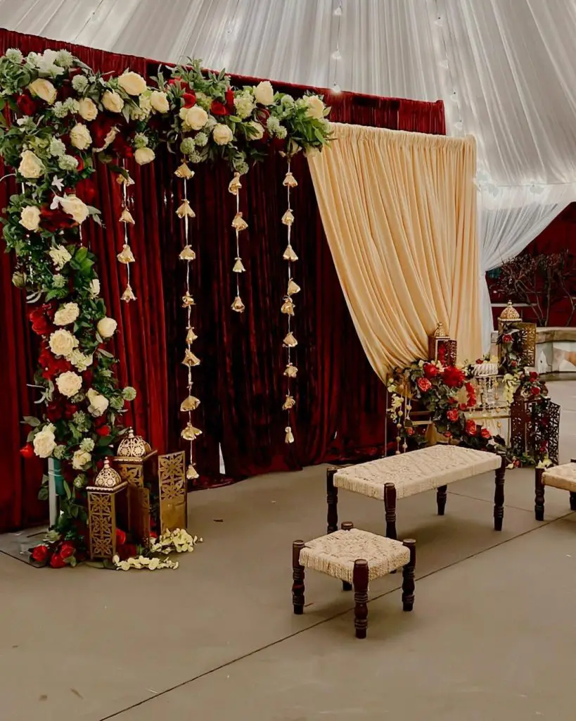 Wedding ceremony under floral decorated wooden arch with seating arrangement.