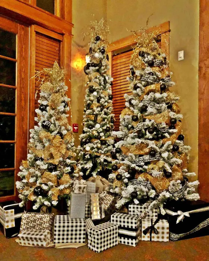Three gold-decorated Christmas trees with black-white presents