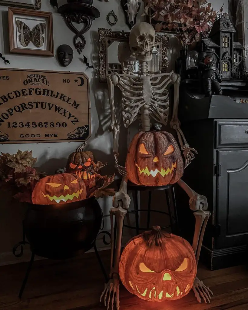 Spooky Halloween display with skeleton pumpkins and occult items