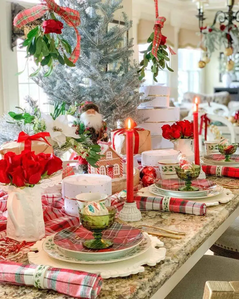 Colorful Christmas table with silver tree, red roses, and traditional holiday decor