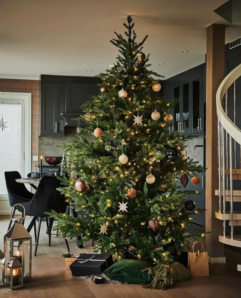Decorated Christmas tree in modern kitchen with dark cabinets