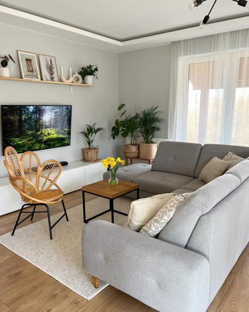 A serene seating area surrounded by plants, art and natural materials.