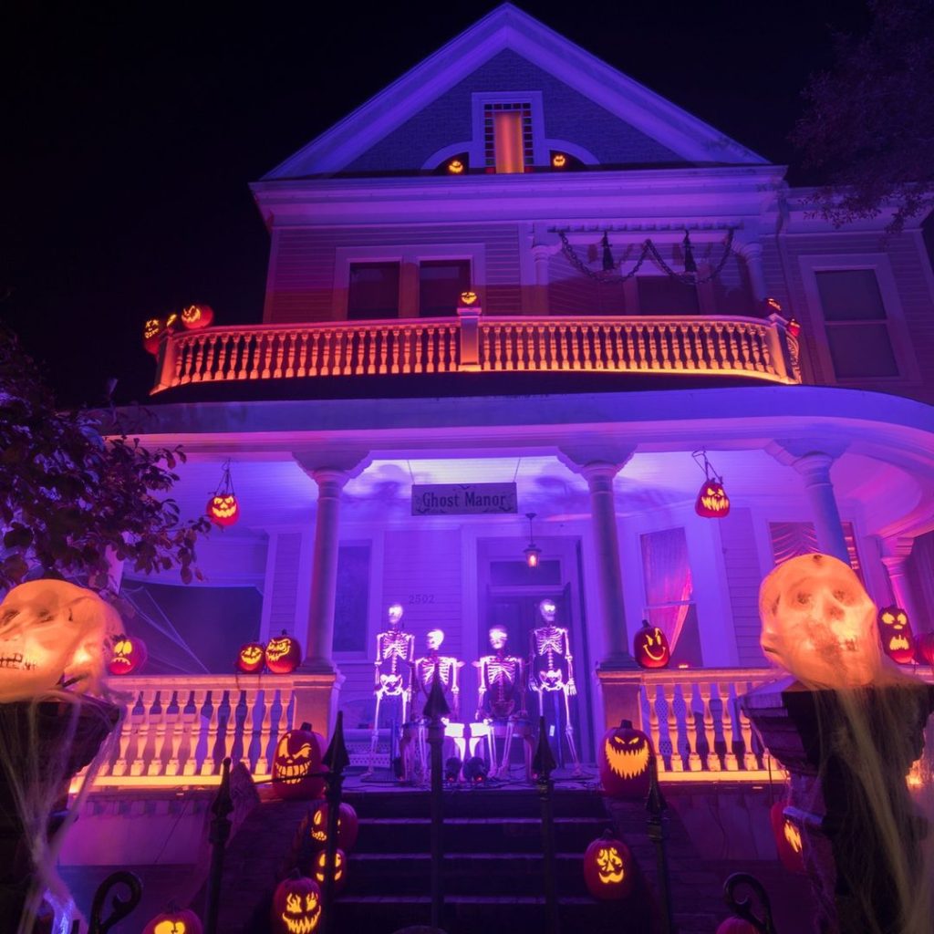 Victorian house lit up for Halloween