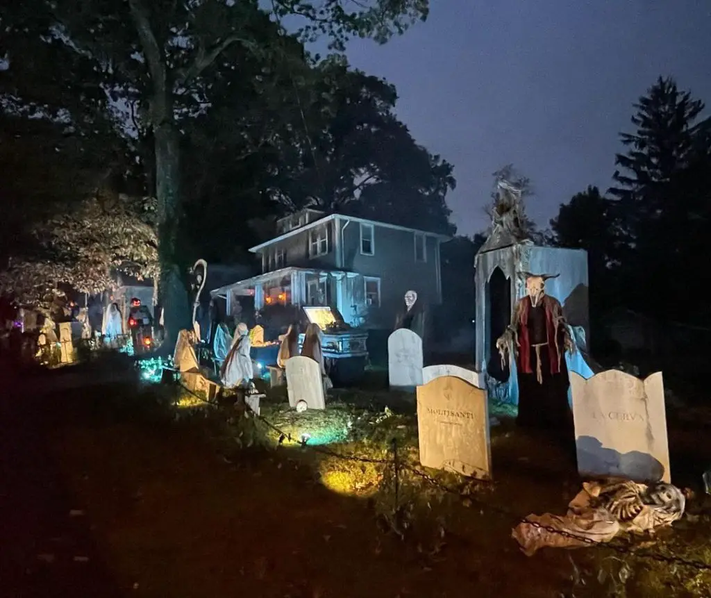Spooky graveyard haunts suburban house yard