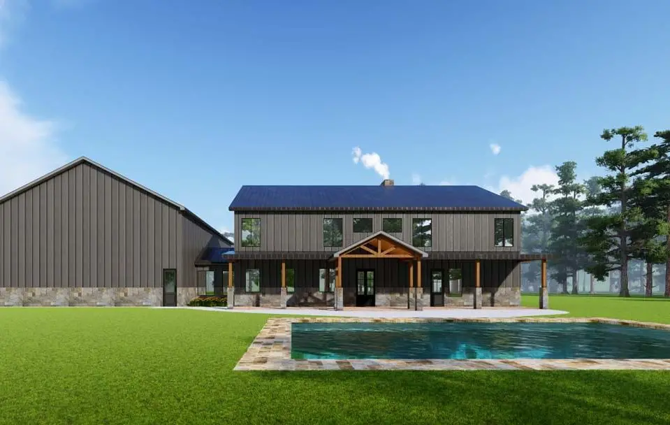 Grey barndominium with pool and stone accents