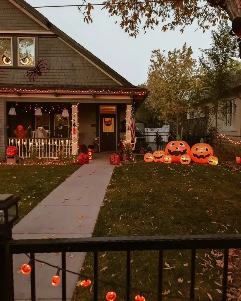 House decorated with pumpkins lights and Halloween decor