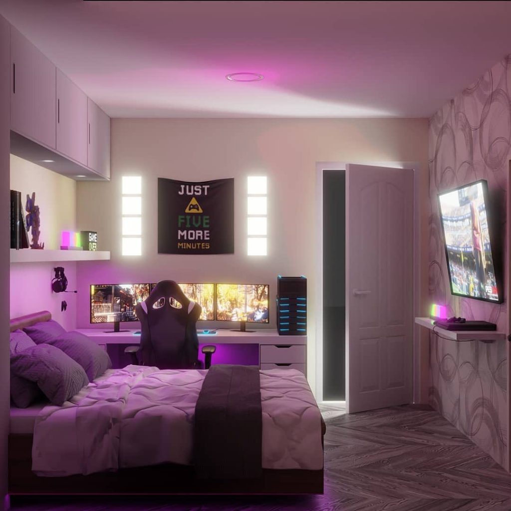 Purple-lit bedroom with gaming setup and bed.
