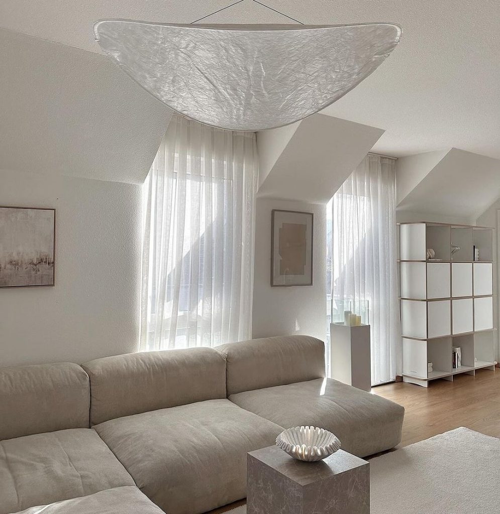 Minimalist living room with sculptural ceiling light"