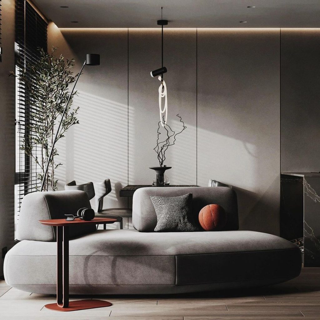Sleek gray living room with curved sofa and minimalist decor.