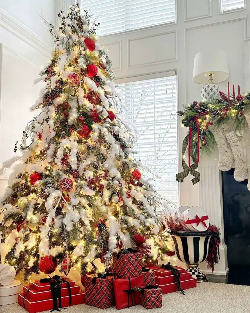 Snow covered Christmas tree with tartan gifts