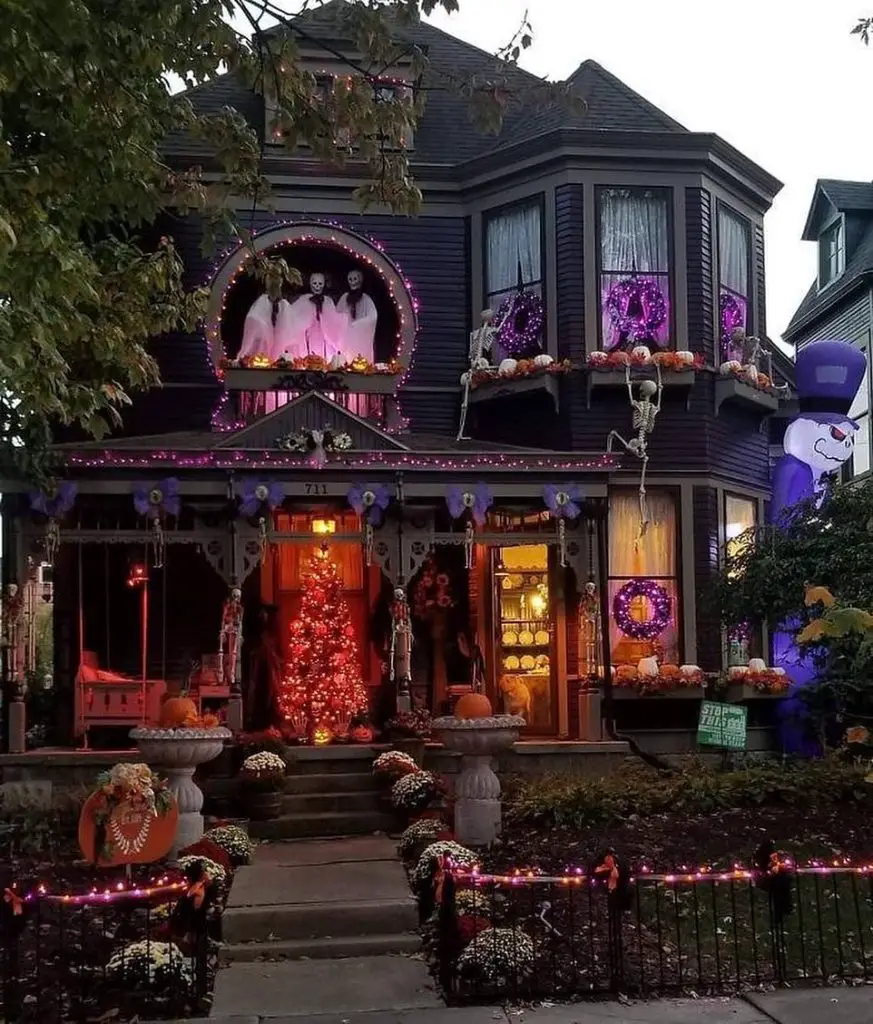 Halloween-decorated house with ghosts lights and skeletons