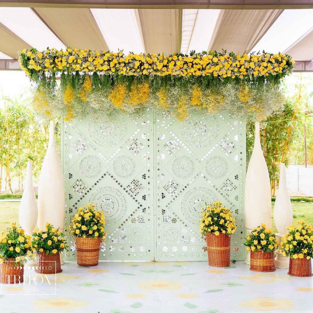 Yellow floral canopy over mint-green patterned backdrop