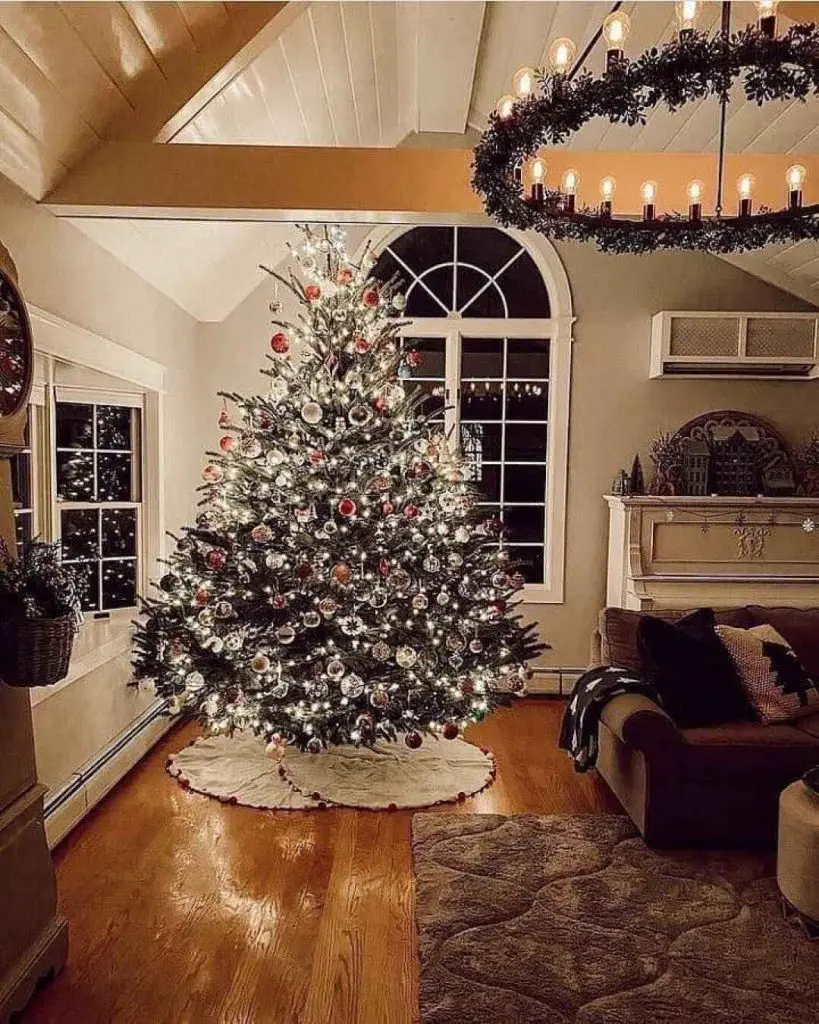 Elegant living room with decorated Christmas tree and arched window
