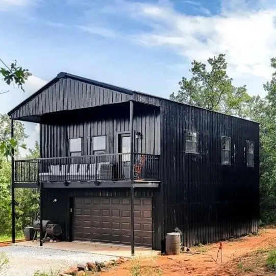 Two story black barndominium with upper deck