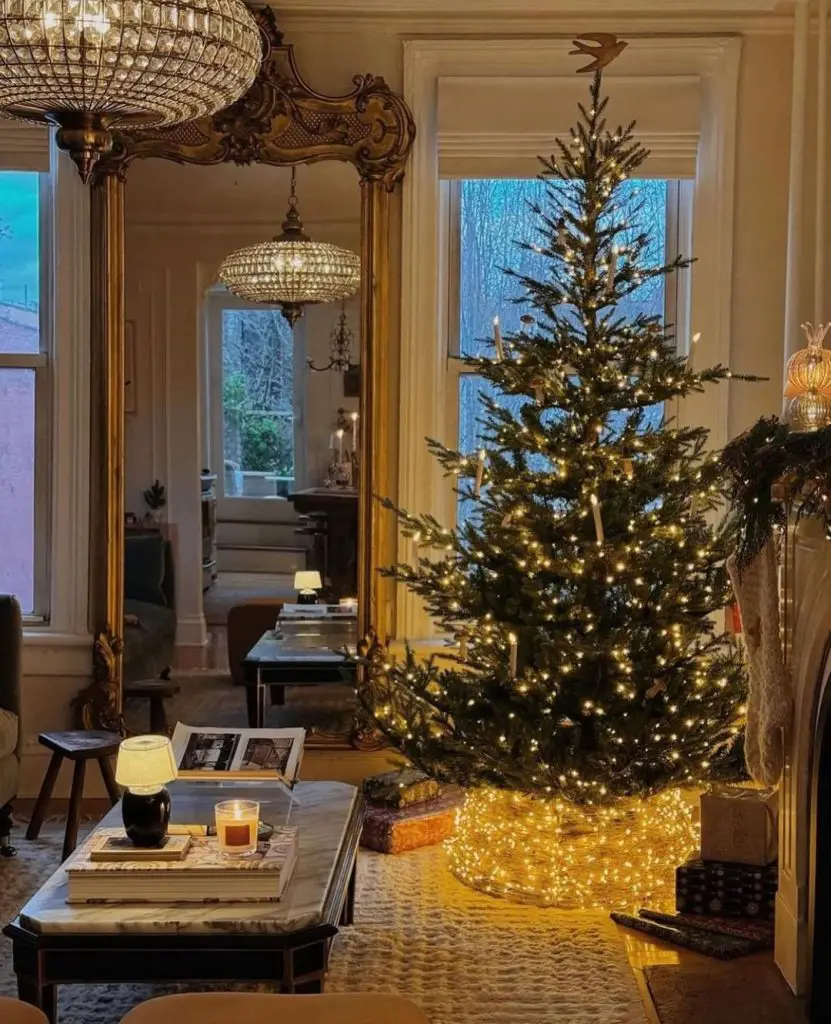 Elegant living room with lit Christmas tree and ornate mirror