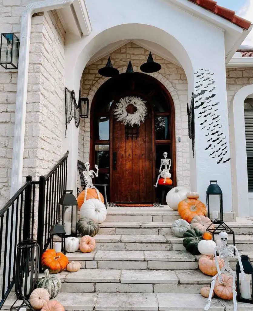 Festive Halloween porch with pumpkins skeletons and witch hats