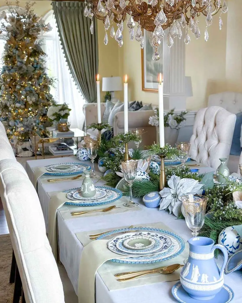 Elegant Christmas table with blue china and crystal chandelier.