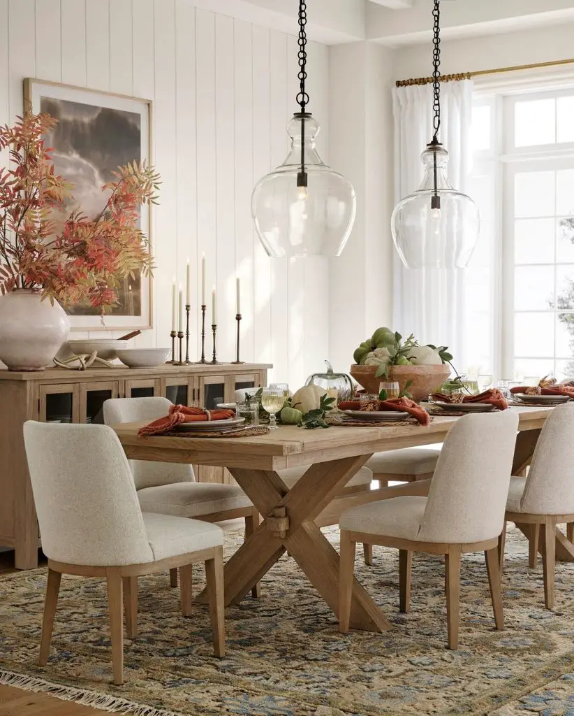 Fall dining room with glass pendants and upholstered chairs