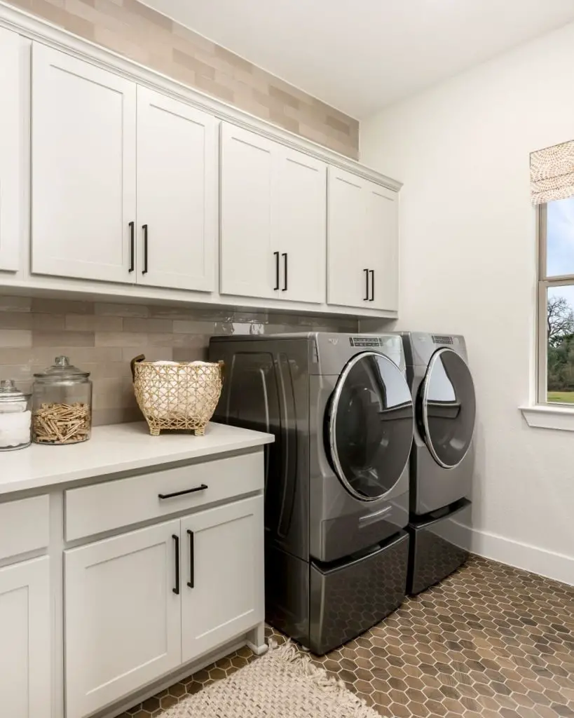 Contemporary white laundry room with hexagon flooring