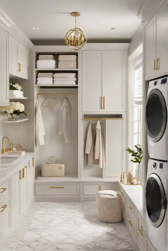 Luxury white laundry mudroom combo with gold accents