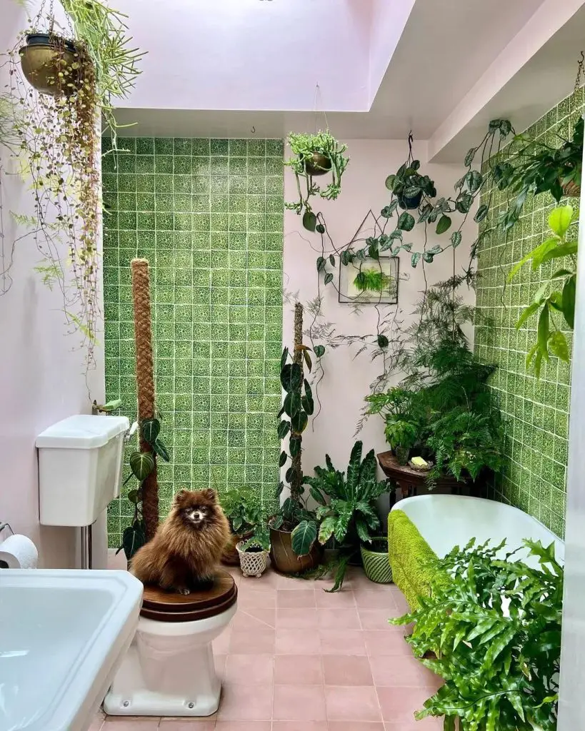 Luxuriant green bathroom design with pink floors and climbing vines