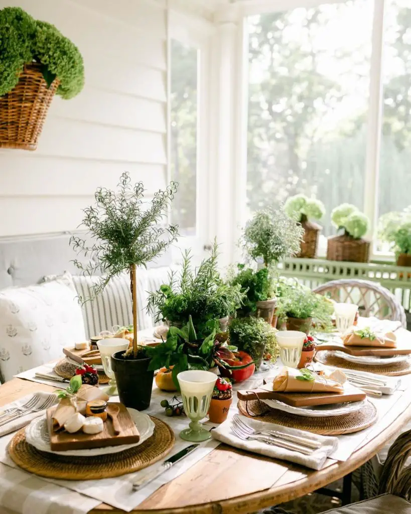 Sunlit herb garden tablescape with woven chargers and potted greenery centerpiece