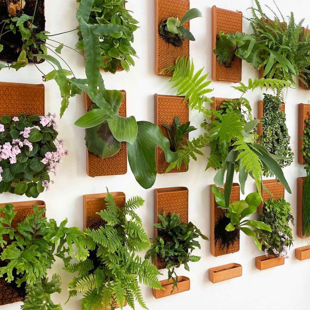 Terracotta geometric planters create organized living wall pattern