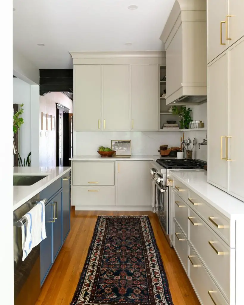 Elegant galley kitchen with brass hardware and Persian runner