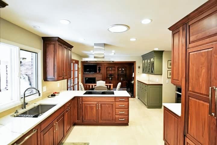 Traditional mahogany kitchen with green accent cabinet