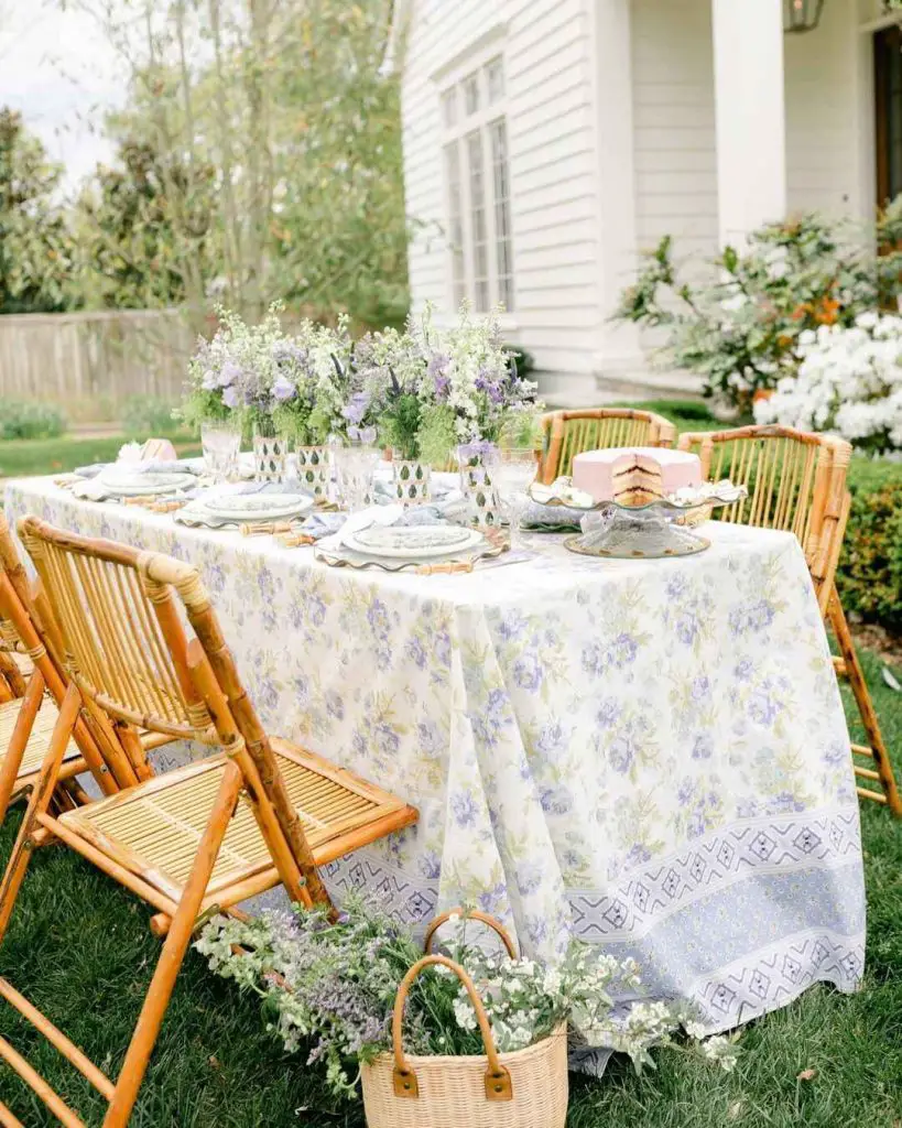 Countryside brunch table with bamboo chairs lavender florals and vintage-inspired place