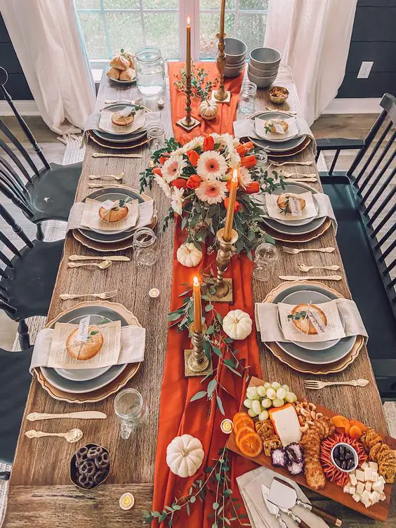 Farmhouse dining table with orange runner white pumpkins and floral centerpiece perfect for fall entertaining
