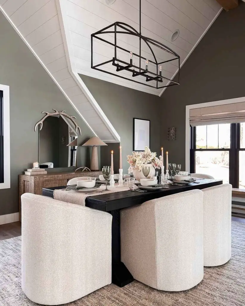 Modern dining room with sage walls and geometric lighting