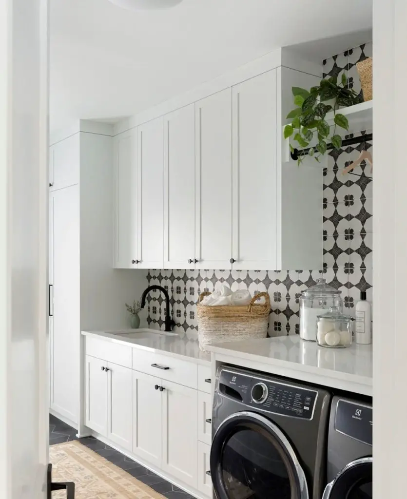 Bright white laundry room with Moroccan tile backsplash and modern appliances