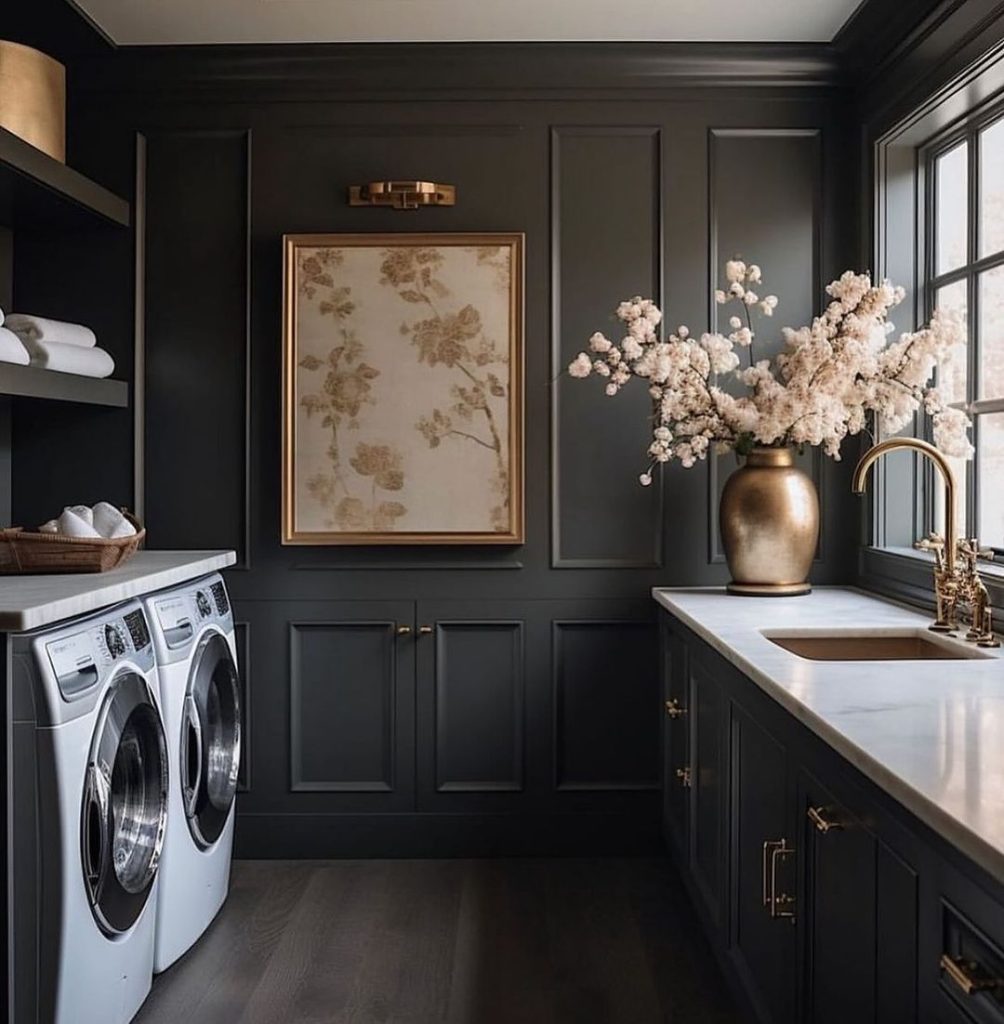 Dramatic black laundry room with gold accents and cherry blossoms