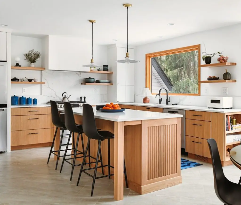 Modern kitchen with oak cabinets and black bar stools